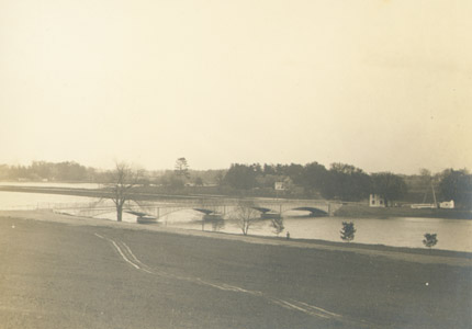 Much like today, in the early 20th century, Harrison Street provided an important connection between Princeton and the Brunswick Pike (U.S. Route 1).   When the Millstone River was impounded to create Lake Carnegie for the Princeton University crew team, a new Harrison Street Bridge was constructed in 1906.  The  A-frame swing bridge, bridge tender’s house and station can be seen just beyond the arched span. 